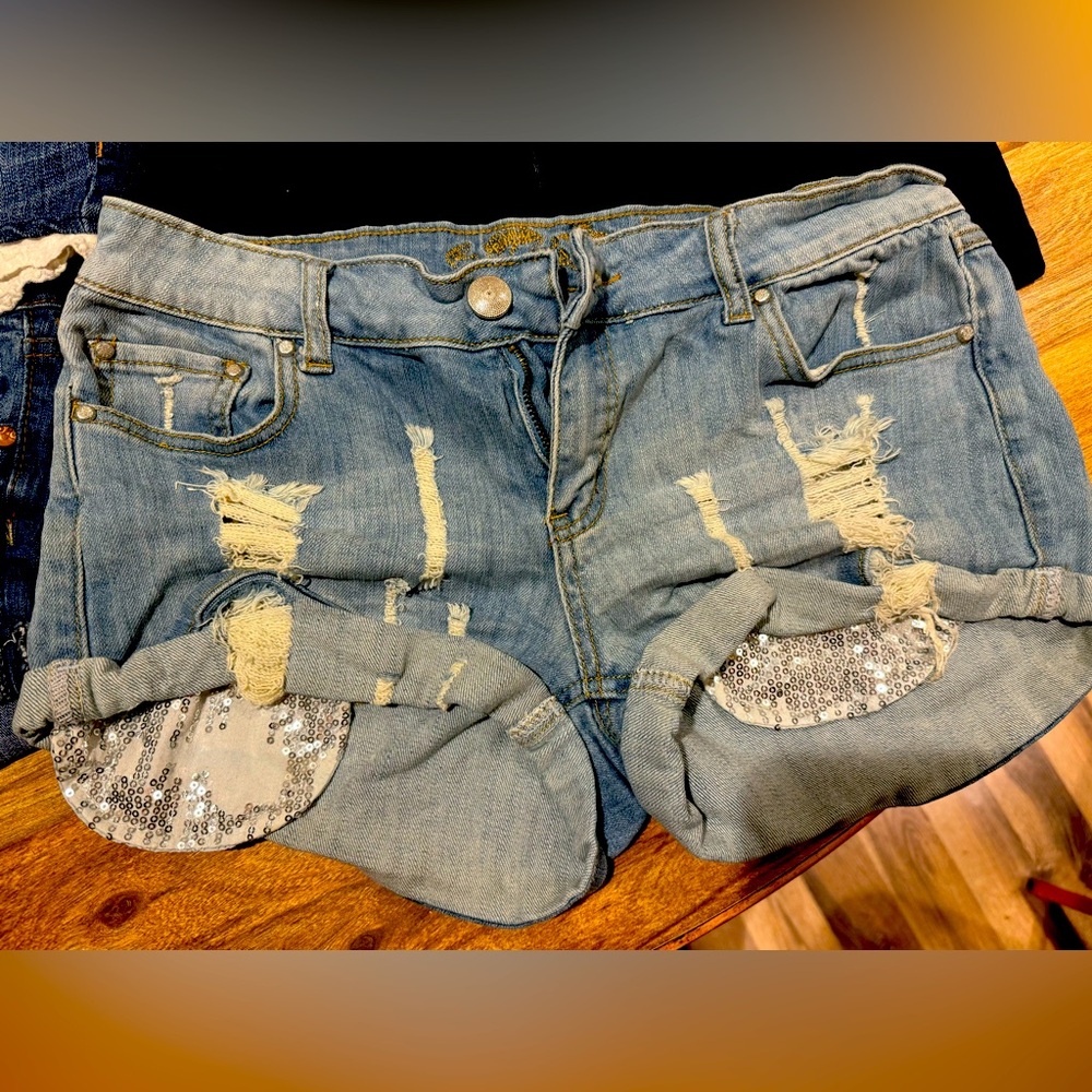 Denim stretch shorts with sequined pockets.